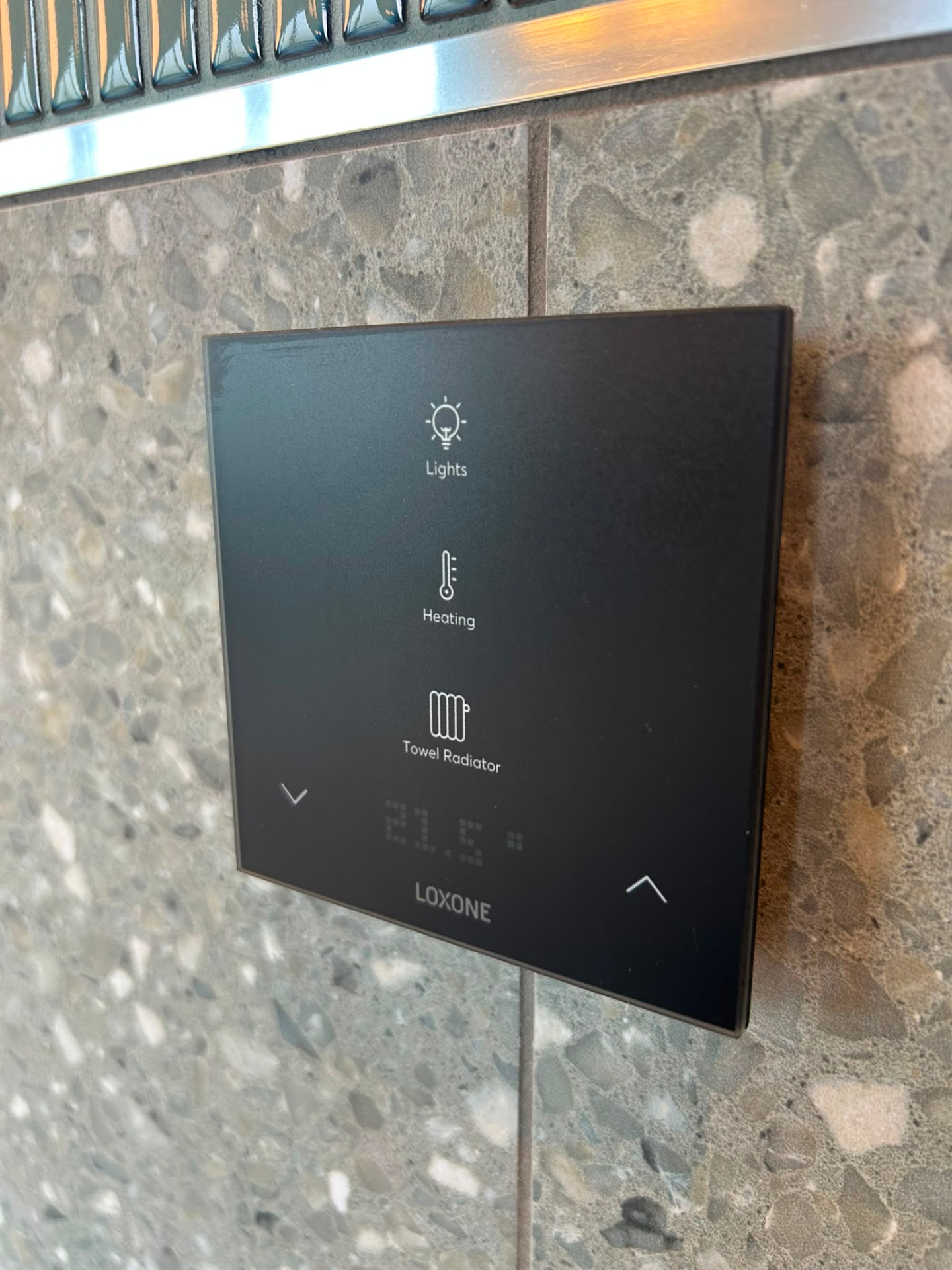 Loxone Touch wall panel controlling lights, heating and towel radiator in a Derby home